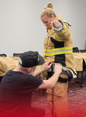 Female Firefighter Being Sized